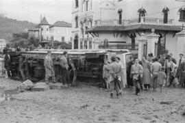 Tranvía volcado ante el sanatorio 18 de julio y calles embarradas por las inundaciones del 29 de octubre de 1955. Málaga. España.